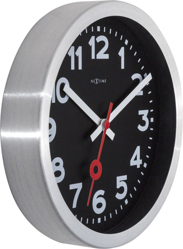Black aluminum NeXtime Station clock, versatile wall or table clock with modern design and clear station number details.