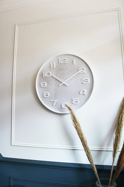 NeXtime Clocks Wood Wall Clock, 35 cm diameter, made of natural wood with a modern design.