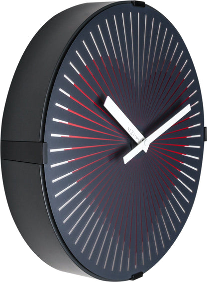Red NeXtime Motion Heart wall clock, 30 cm plastic design with moving hands, shown from the left side.