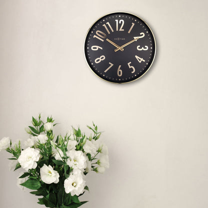 NeXtime Clocks Alchemy 40cm metal wall clock with silent operation, modern design, and sleek black finish.
