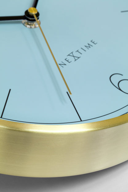 NeXtime Bolero wandklok van 25cm met turquoise, wit en zwart metalen design, geluidloos en stijlvol voor in huis.