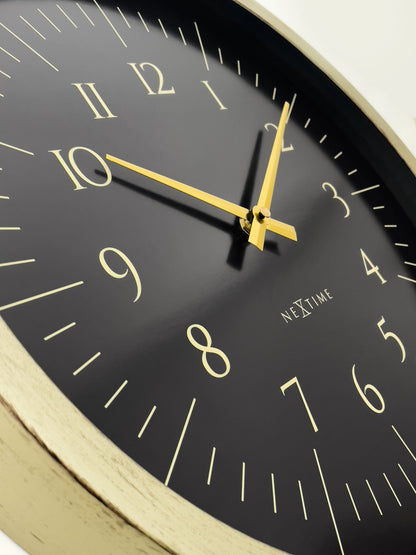 Close-up of NeXtime Galaxy wall clock in black and white, showing the detailed plastic clock face with sleek design.