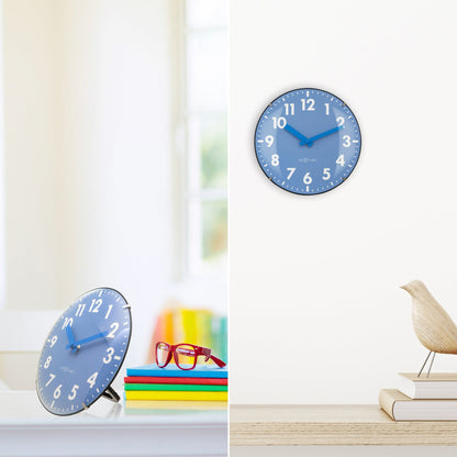 NeXtime Duomo Mini wall or table clock with 20cm glass dome lens, silent movement, black frame, and minimalist design.