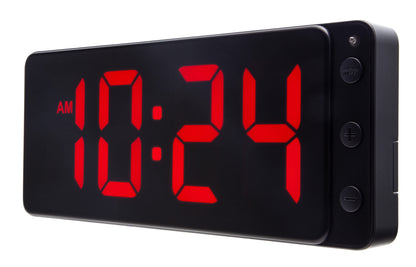 NeXtime digital LED wall or table clock showing a red display with a sleek black frame and modern design.