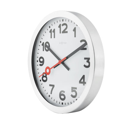 NeXtime Clocks aluminum wall or table clock with station number design, featuring a sleek modern appearance and clear time display.