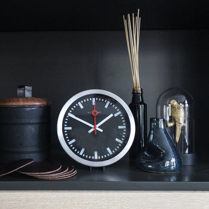 Black aluminum Station Stripe wall or table clock by NeXtime Clocks featuring a sleek design and modern style.