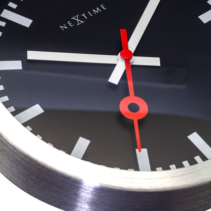 NeXtime Clocks black aluminum Station Stripe wall or table clock with modern design and striped pattern detail.