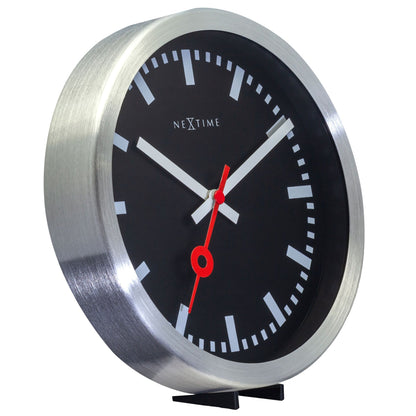 NeXtime Clocks black aluminum Station Stripe wall or table clock showing a sleek design with bold striped pattern.
