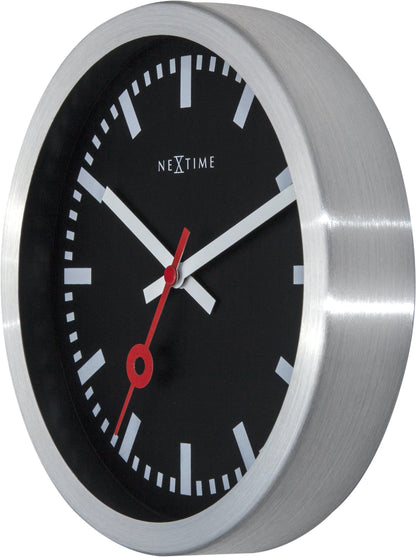 Black aluminum Station Stripe wall or table clock by NeXtime Clocks, showing a sleek modern design with a minimalist face.