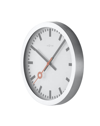 NeXtime Clocks aluminum station stripe wall or table clock with minimalist design, showing a side view with clock face and striped pattern.