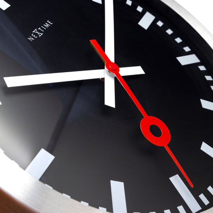 Black aluminum NeXtime Station Stripe wall or table clock with a sleek, modern design and bold striped face detail.
