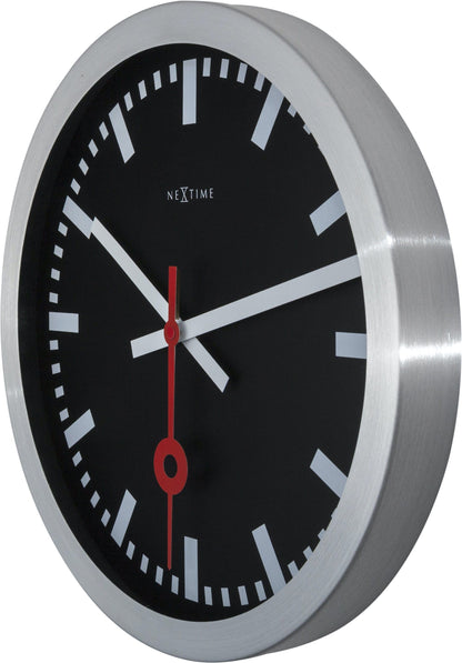 Black aluminum Station Stripe wall or table clock by NeXtime Clocks, showing the right side view with clock face and sleek design.