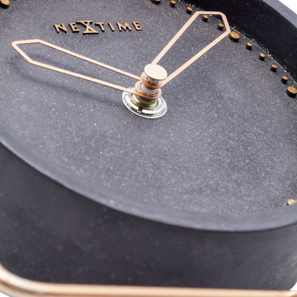 NeXtime Clocks table clock made of polyresin, measuring 17.5 x 15.5 x 5 cm, with a detailed cross design on the surface.