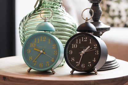 NeXtime Clocks metal alarm clock with 16cm diameter and loud single bell sound, featuring a classic design and sturdy metal construction.