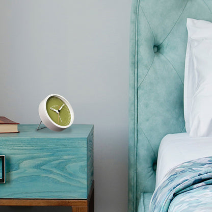 Small NeXtime Clocks metal table alarm clock with light function, silent operation, measuring 9x9x7.5cm, in a modern design.