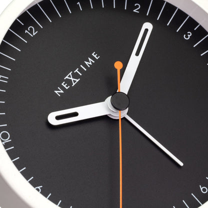 Close-up of NeXtime small metal table alarm clock with light function, silent operation, 9x9x7.5cm, detailed design.