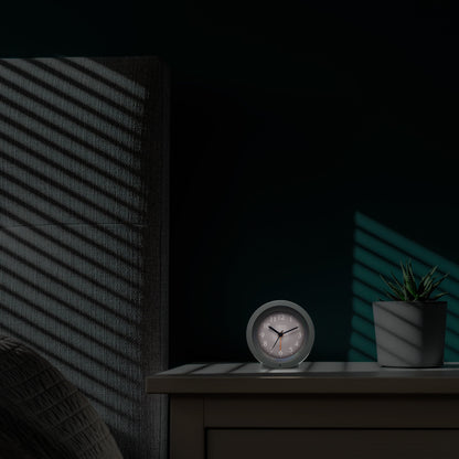NeXtime Circle alarm clock with silent light dial, measuring 10.5cm x 3.6cm, modern round design for bedside or desk use.