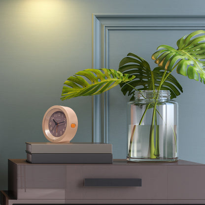 NeXtime Circle alarm clock with silent light dial, 10.5cm x 3.6cm, modern design on a table.