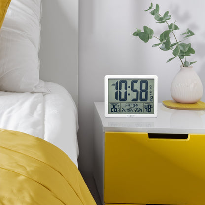 NeXtime alarm clock with digital display, weather station features, ABS material, 17.3x14x2.7cm, designed for wall or table use.