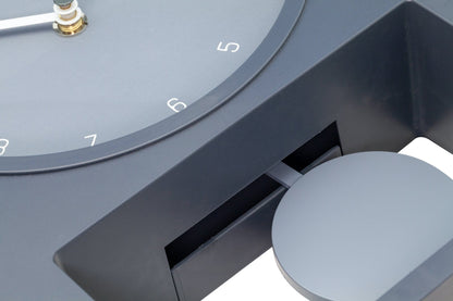 NeXtime Swing Table Clock, 30x20 cm plastic clock with a modern design, featuring a swinging pendulum on a desk surface.