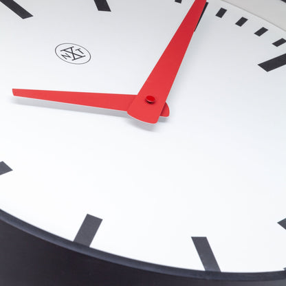 Close-up of NeXtime Clocks Newcastle wall clock, 25.5cm, silent plastic design with detailed face and sleek black hands.
