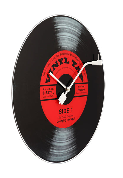 NeXtime Clocks vinyl-themed wall clock with a 43 cm glass face, showcasing a stylish vinyl record design.