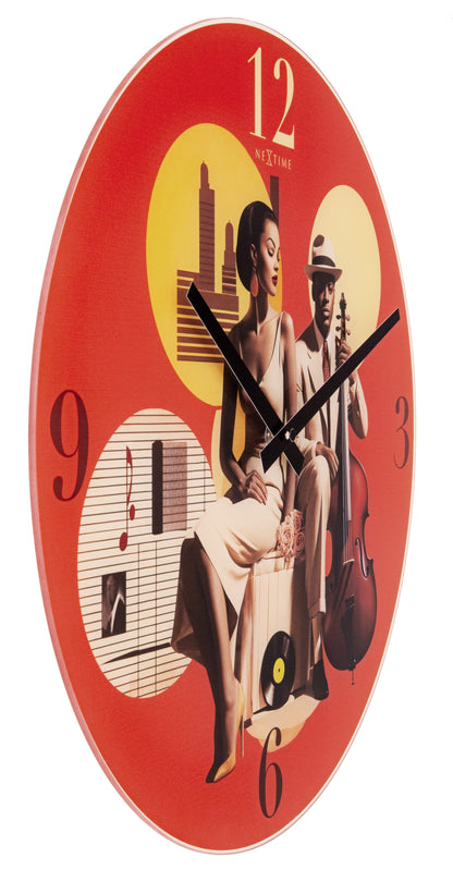 NeXtime Clocks Jazz wall clock, 43cm with multicolour glass face, silent mechanism, and modern design, shown from the left side.