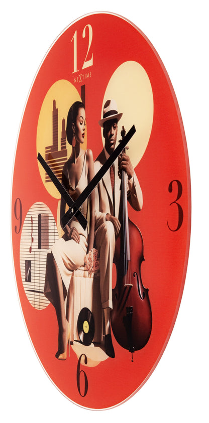 NeXtime Clocks 43cm silent multicolour glass wall clock with 'Jazz' design, showing colorful hour and minute hands.