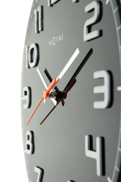 NeXtime Clocks Classy Round wall clock with glass face, 30x3.5 cm, showcasing a sleek, minimalist design.