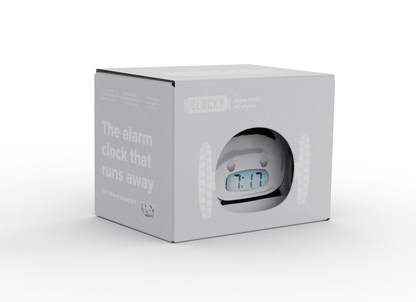 Chrome alarm clock on wheels by NeXtime Clocks, featuring a sleek design and digital display, shown from an angled perspective.